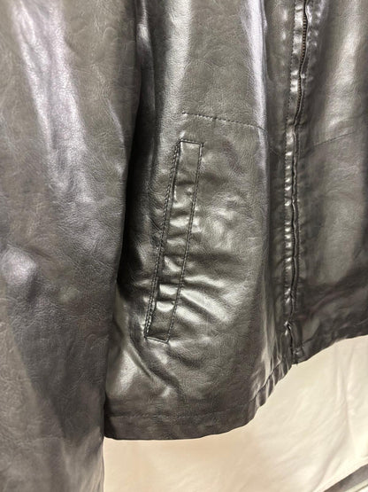 Close-up of a black leather jacket on a mannequin.