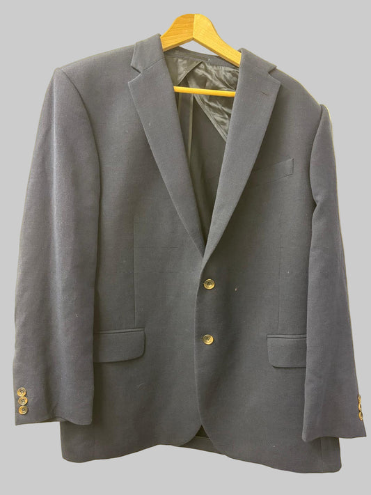 Gray blazer on a yellow hanger against a beige background