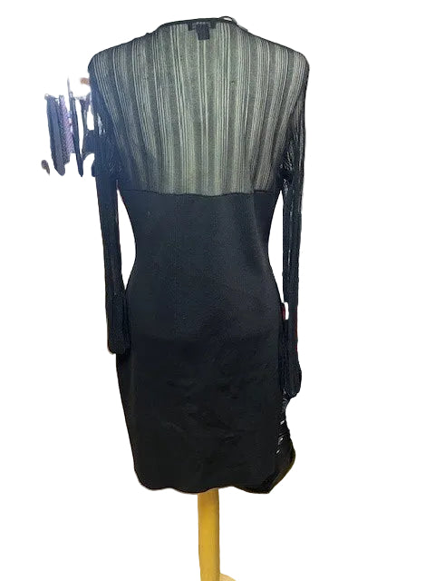 Black dress with green pattern on a rack in a store setting