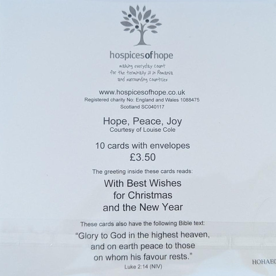 A clear plastic sleeve containing a white card from Hospices of Hope, printed with text and a small tree logo, placed on a light brown wooden surface.