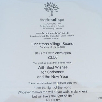 A white printed card or booklet insert enclosed in a clear plastic sleeve, photographed from above on a light wood surface. The card contains small black text and a floral logo near the bottom right.